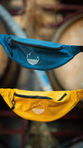 Cloudwater branded bum bags, in teal and mustard yellow