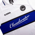 Front of White Cloudwater Brew x COPA Retro Football Shirt sports jersey with blue stripe featuring 'Cloudwater' branding and Copa logo.