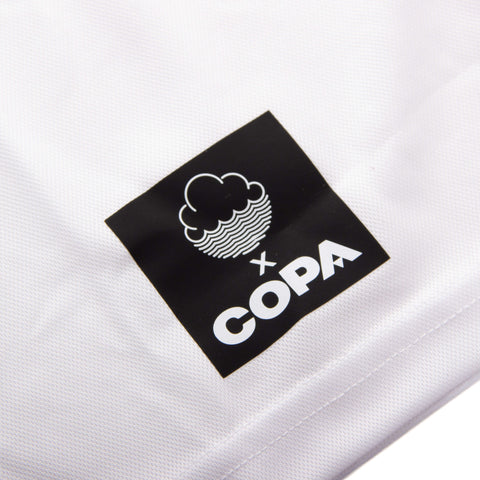Close-up of front shirt label on Back of White Cloudwater Brew x COPA Retro Football Shirt sports jersey.