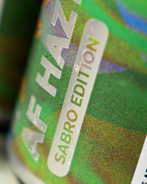 Close-up of a can with 'AF Haze Sabro Edition' text on a colorful background