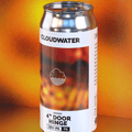 A can of Cloudwater 4" Door Hinge Double Dry-Hopped IPA, containing orange zest and hops that intensify the orangey flavour. The can features a white label with a fiery orange and red graphic, set against a warm, blurred orange background with a clear reflection below.
