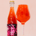 Bottle and glass of Kyema - red raspberry fruited wild Barrel-Aged Sour beer on a light pink background