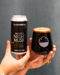 Person holding a Night Music Imperial Stout, Maple edition can with a Cloudwater branded Harmony glass with the delicious, delectable, delightful drink