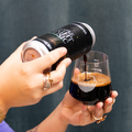 Person pouring a Night Music Imperial Stout, Maple edition from a can into a Cloudwater branded Harmony glass