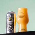A silver can of Cloudwater Proper DIPA next to a matching Craftmaster glass full of the sweet, sticky and dank yellow-orange double IPA