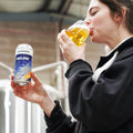 One of Cloudwater's brewers tasting a can of AGLOW West Coast IPA fresh off the canning line