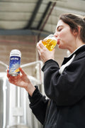 One of Cloudwater's brewers tasting a can of AGLOW West Coast IPA fresh off the canning line