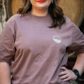 'Cloudy' premium baggy fit tee in Kaffa Coffee dusky purple/brown being worn by a woman