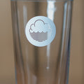 Cloudwater branded pint glass being filled with stout from a height