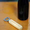 A wooden bottle opener with 'Cloudwater Barrel Project' engraved on the handle